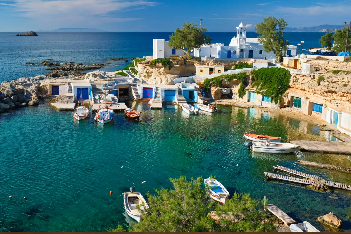 Small harbour in Milos, one of the best islands to buy a house in Greece