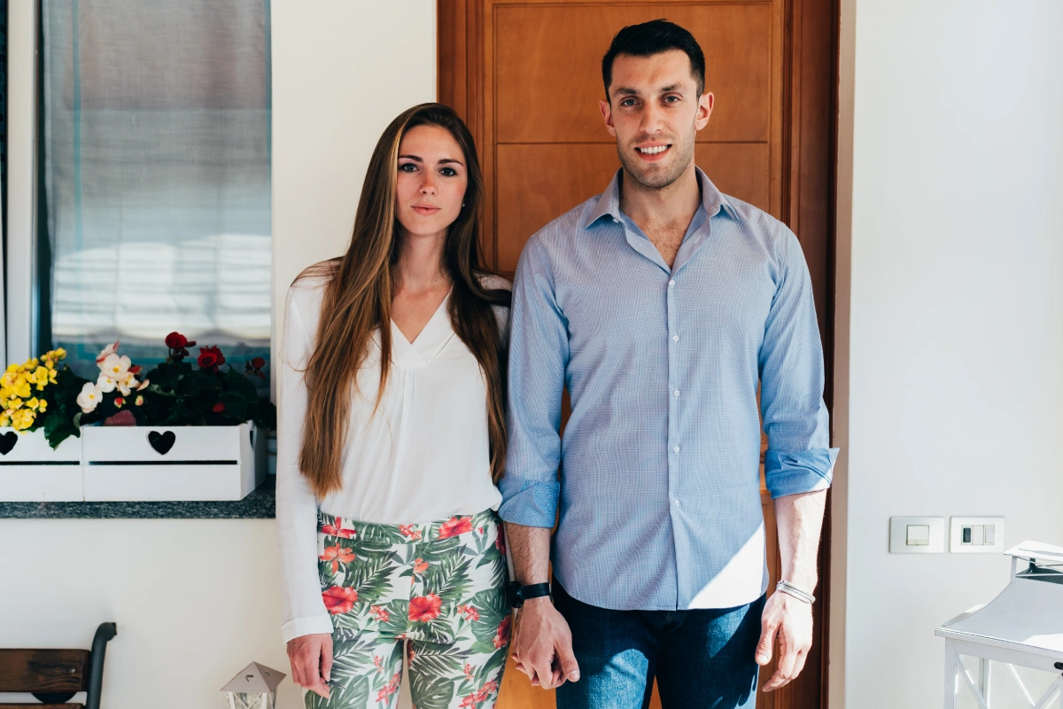 Foreign couple in front of the entrance to their new house in Greece