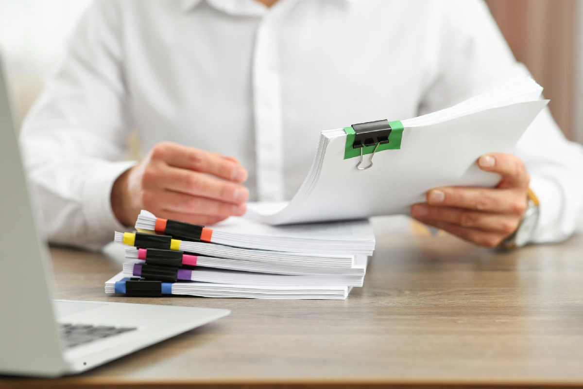An expert examines documentation relating to the purchase of a house