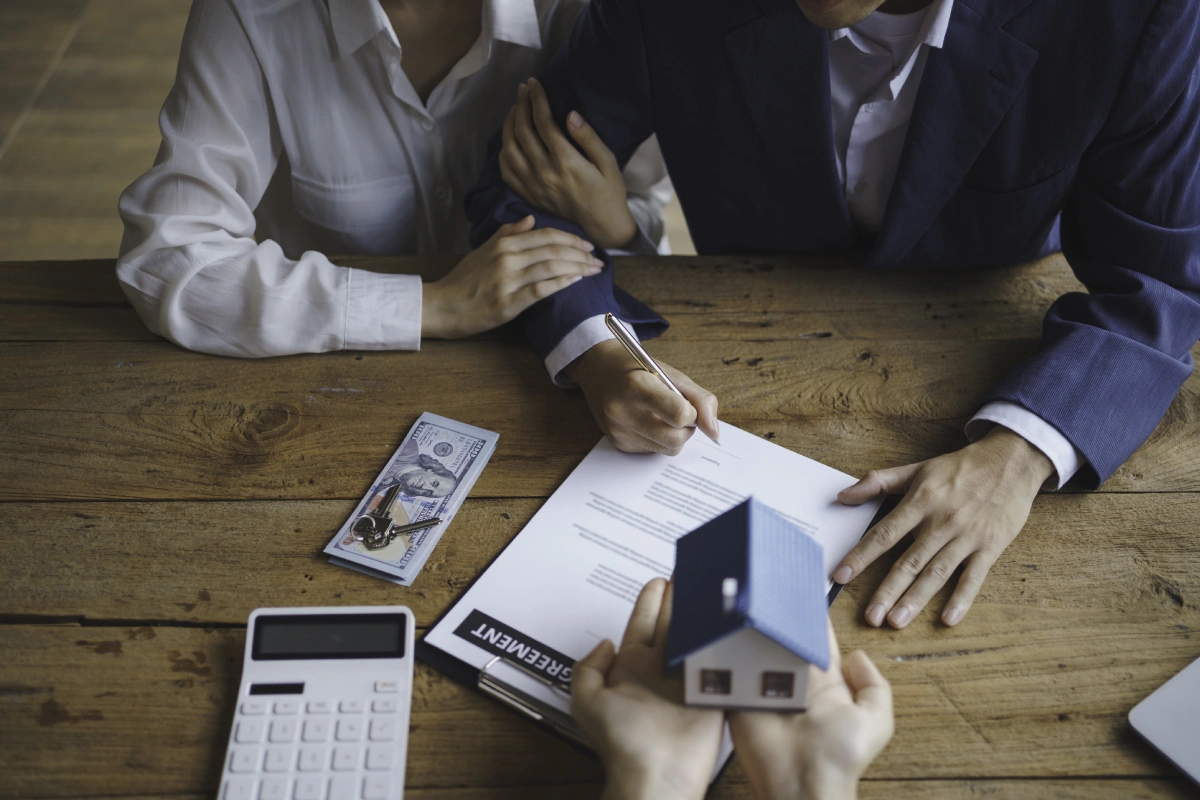 Customers at a bank discussing a contract to request a mortgage in Greece