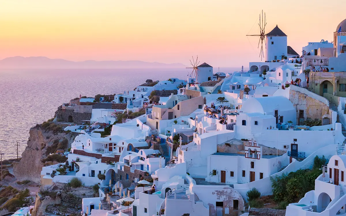 Sunset at the Greek village of Oia Santorini Greece with a view over the ocean caldera