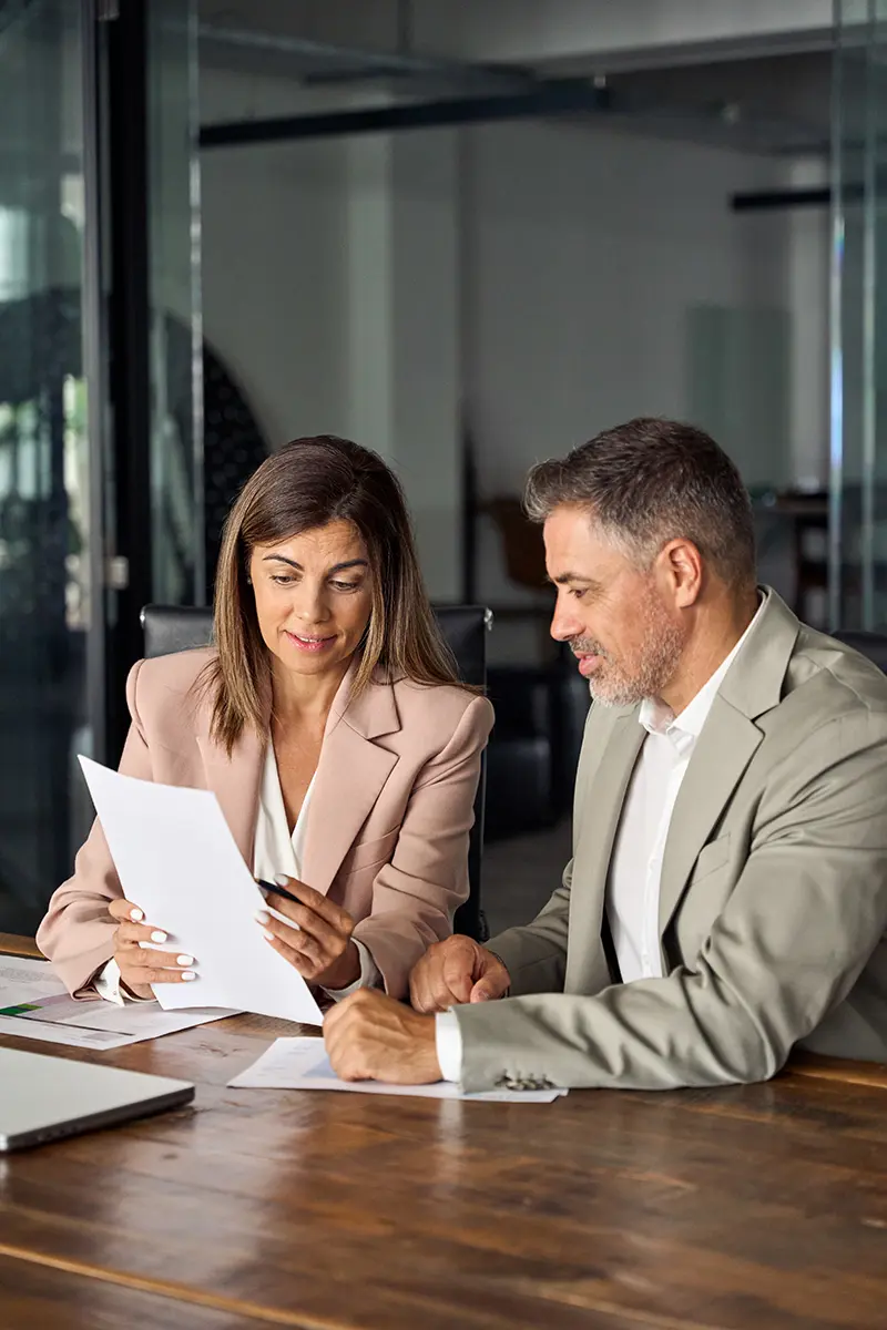 Female lawyer reviewing contract with client at meeting